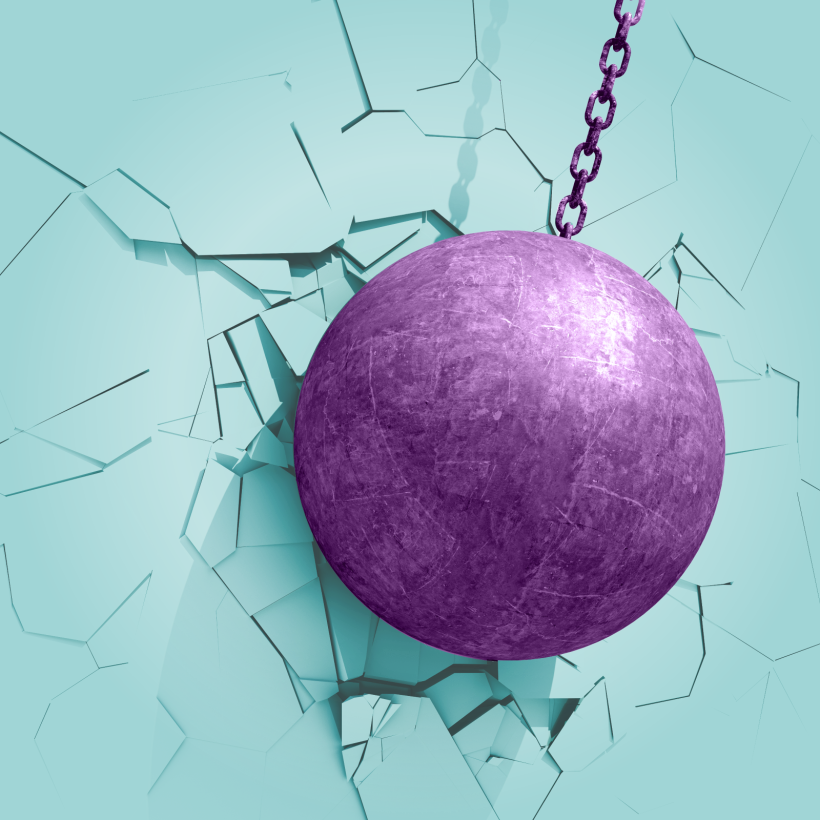 Beeld van een sloopkogel die een muur breekt.