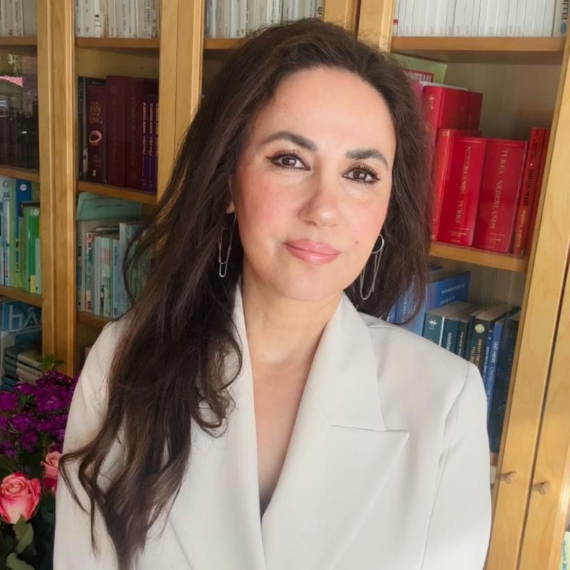 Ayse Yigit voor haar boekenkast