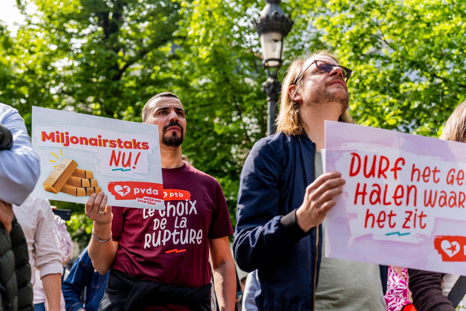 Betoger met een bord 'Miljonairstaks nu'